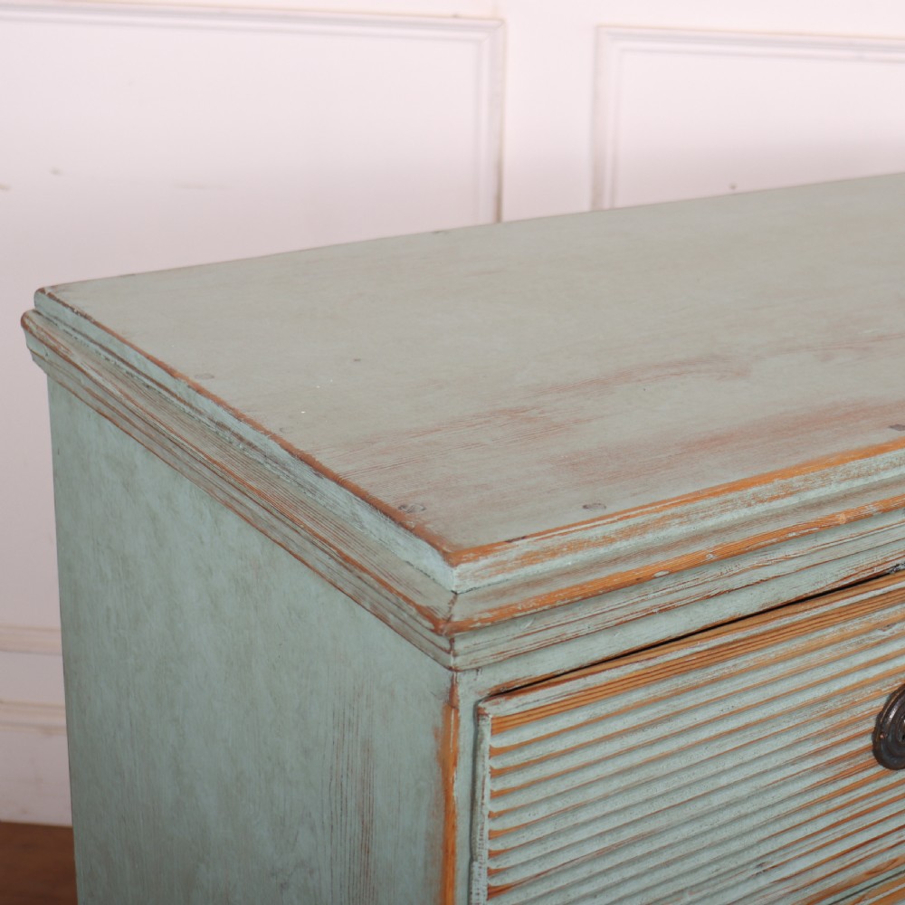 A Swedish painted pine commode featuring horizontal fluted drawer fronts, a pale blue distressed finish, and iron hardware. View IX