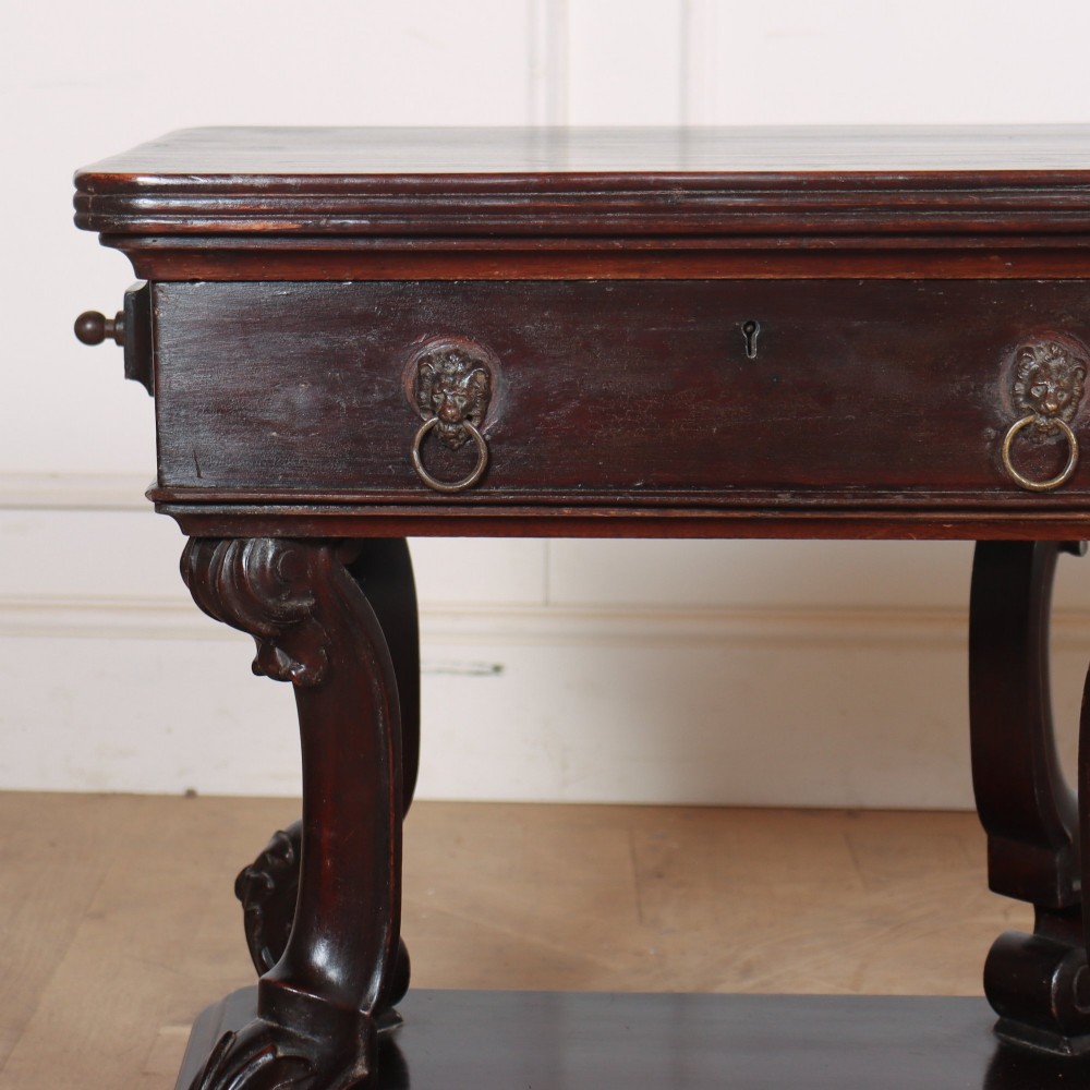 A pair of dark mahogany bedside tables featuring carved scroll supports, upper and lower drawers with brass drop-ring handles, resting on solid plinth bases. View VI