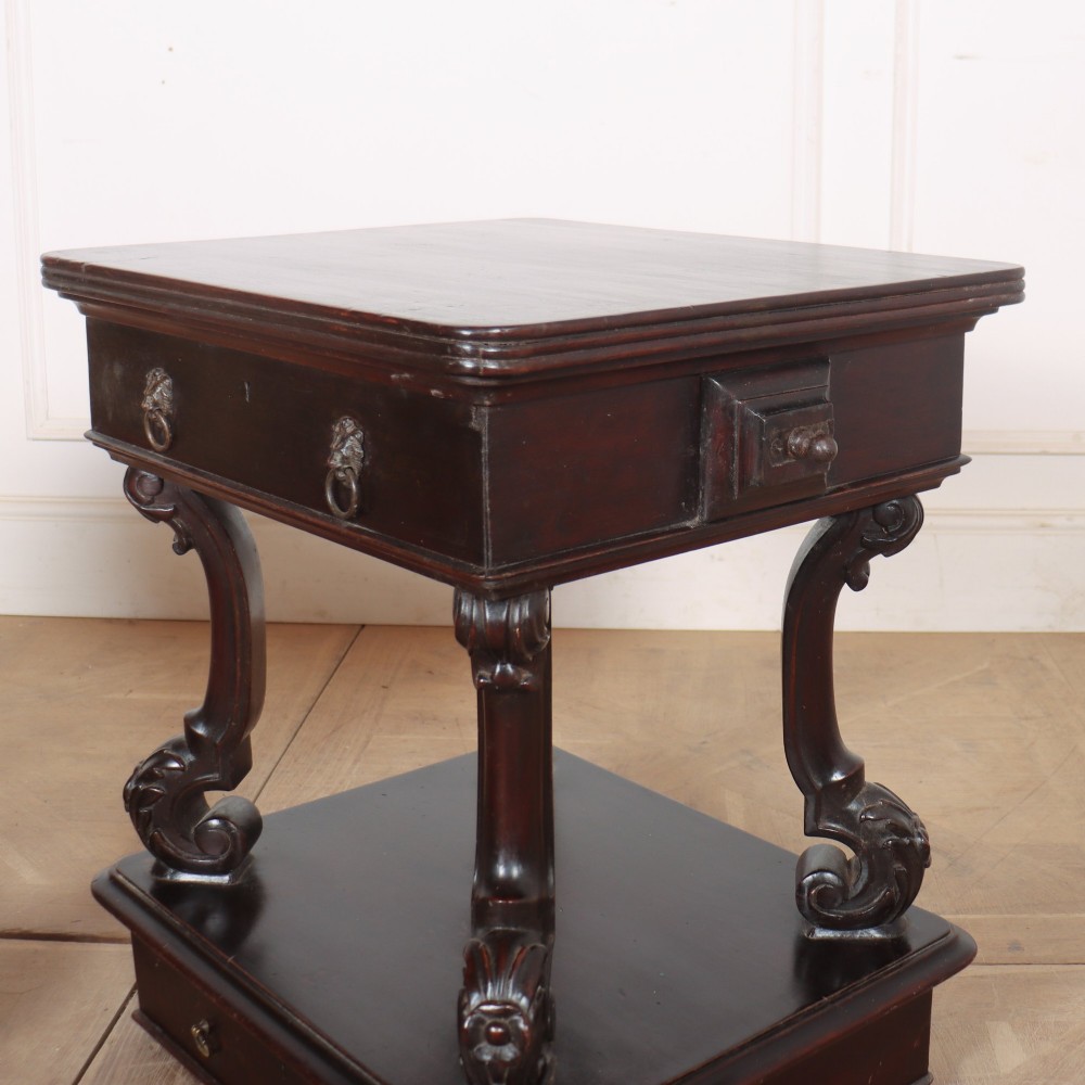 A pair of dark mahogany bedside tables featuring carved scroll supports, upper and lower drawers with brass drop-ring handles, resting on solid plinth bases. View X