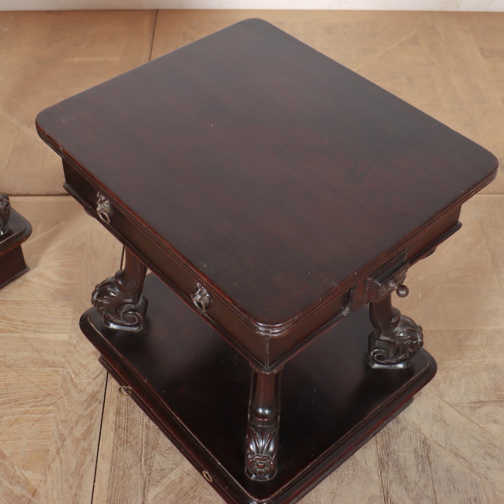 A pair of dark mahogany bedside tables featuring carved scroll supports, upper and lower drawers with brass drop-ring handles, resting on solid plinth bases. View XII