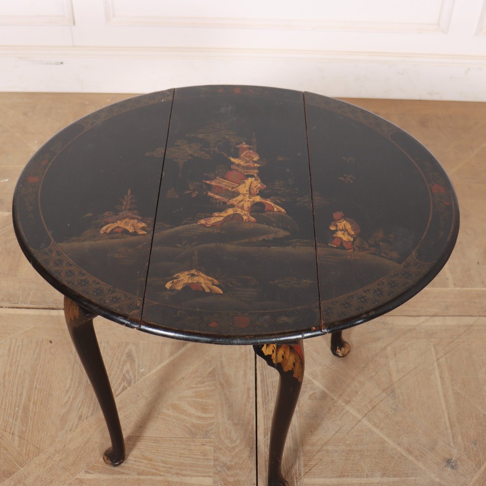 A small black lacquered drop-leaf side table decorated with gold Chinoiserie painted details and slender cabriole legs. View IV