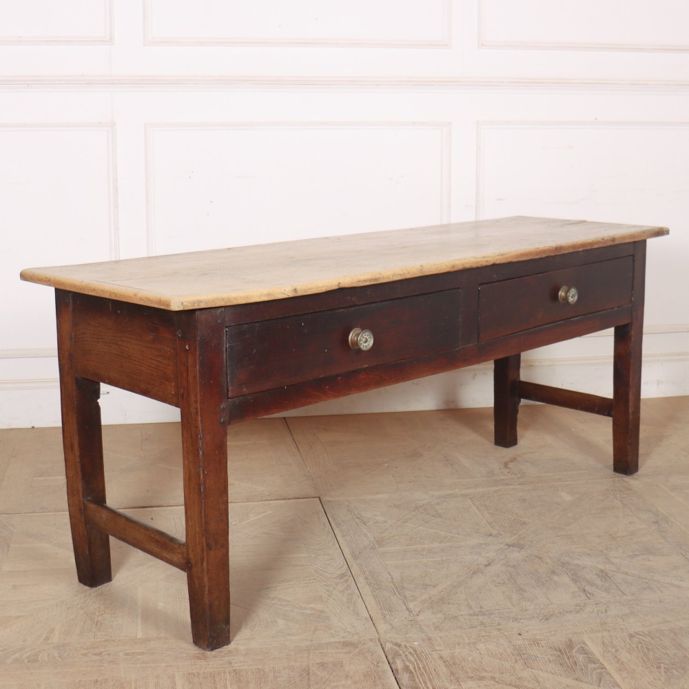 A dark-stained Welsh oak dresser base featuring two wide drawers with circular knobs and a light scrubbed timber top surface. View VII