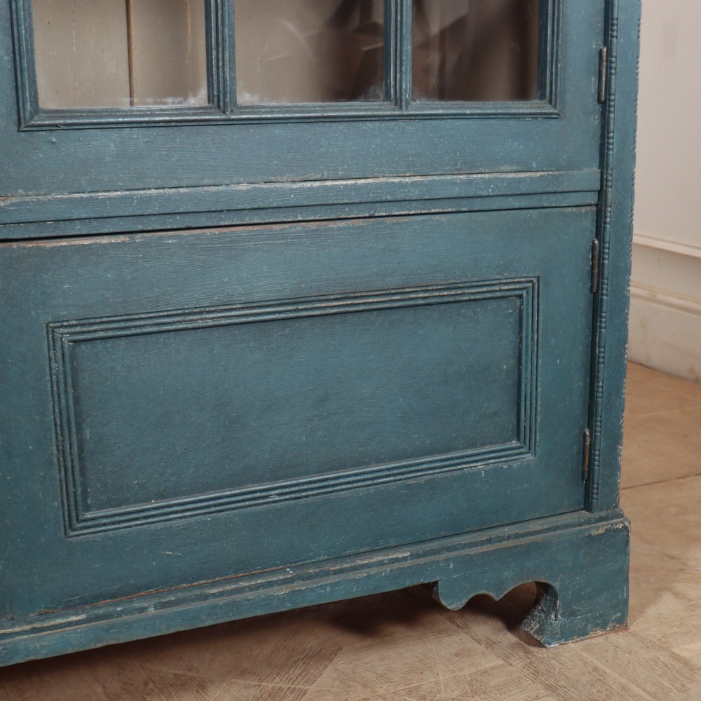 A pair of tall painted teal blue wooden library bookcases with multi-pane glazed doors, moulded cornices, and lower paneled drawers. View VIII