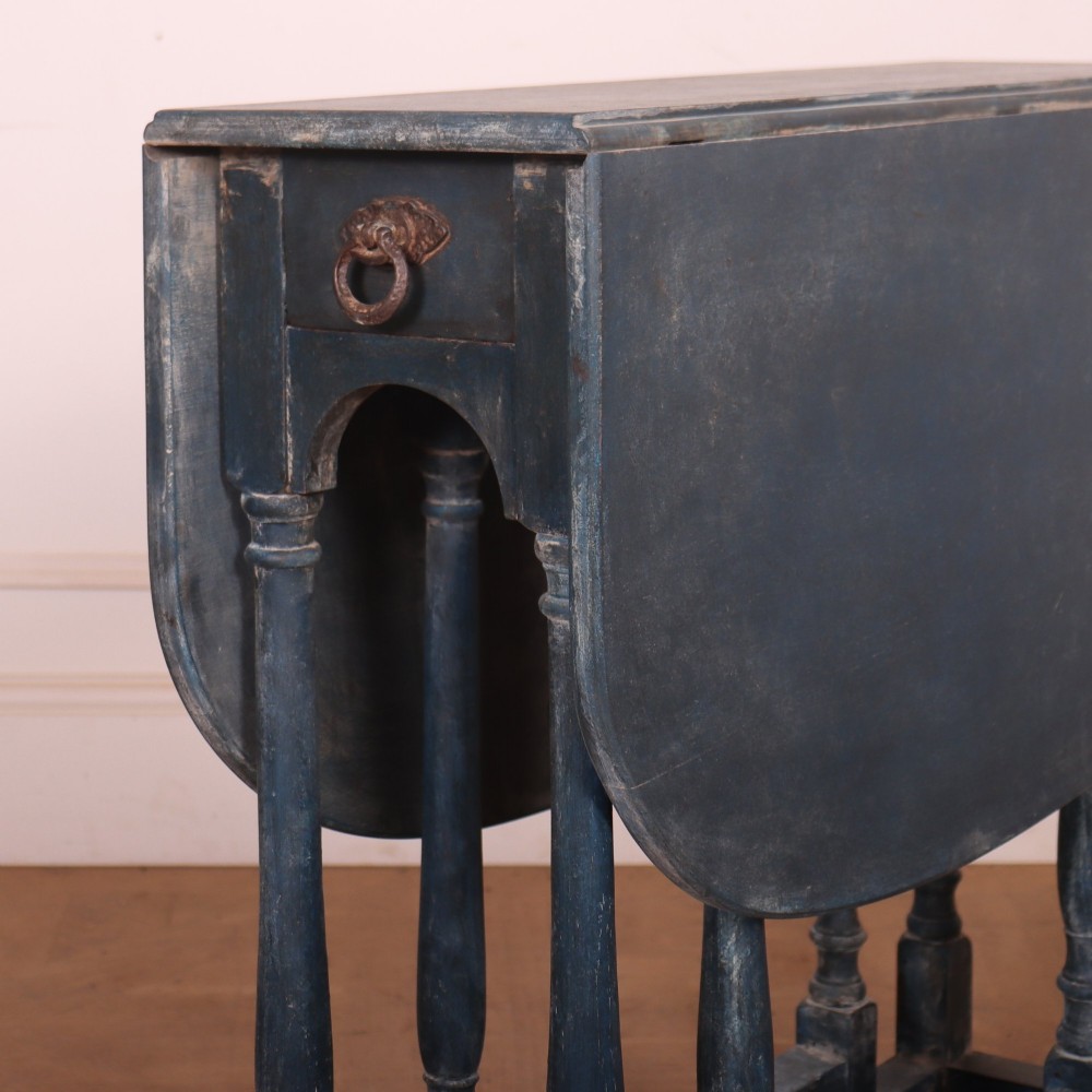 A blue painted antique spider leg drop-leaf table shown with its hinged side leaves folded down, revealing slender turned legs and stretchers. View II