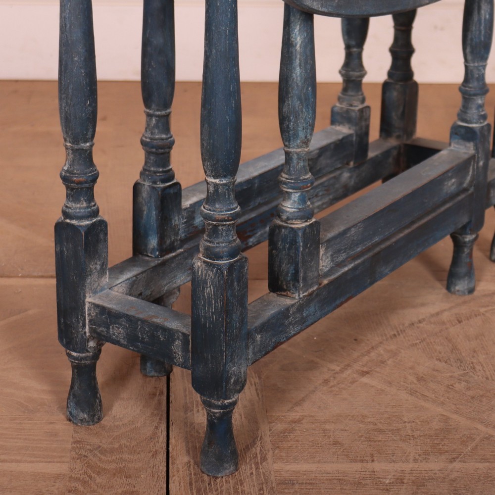 A blue painted antique spider leg drop-leaf table shown with its hinged side leaves folded down, revealing slender turned legs and stretchers. View III