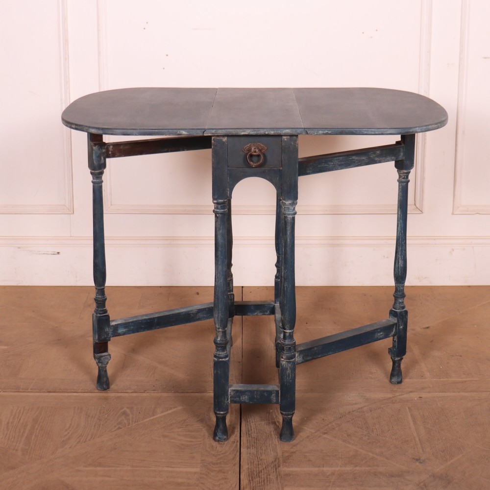 A blue painted antique spider leg drop-leaf table shown with its hinged side leaves folded down, revealing slender turned legs and stretchers. View IV