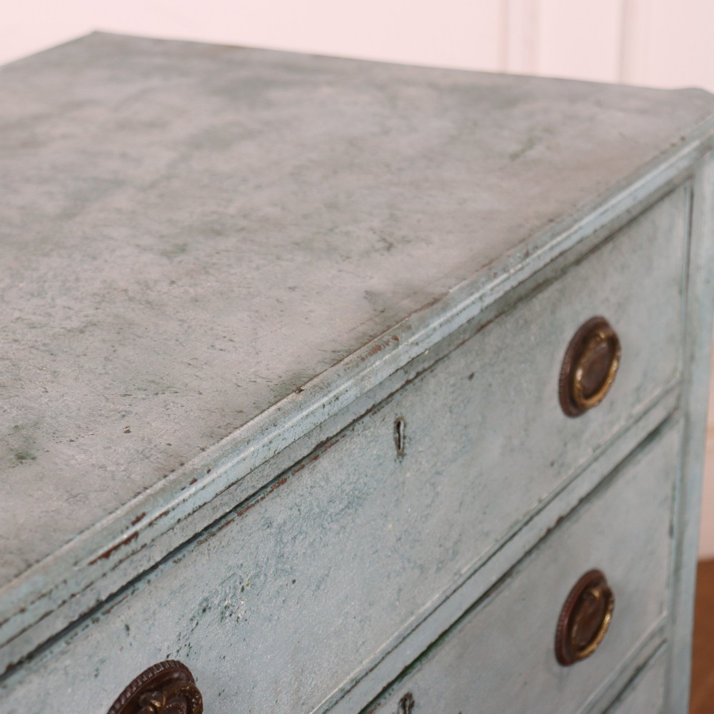 A pale blue painted Swedish commode with four drawers, oval brass pull handles, and square tapered feet. View IX