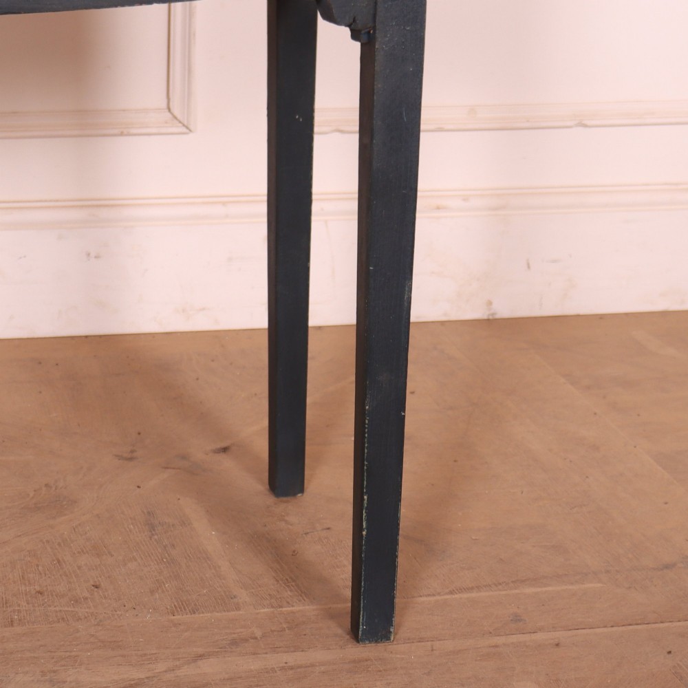A dark painted antique bowfront console table featuring four drawers with circular wooden knob handles and slender square tapered legs. View IV