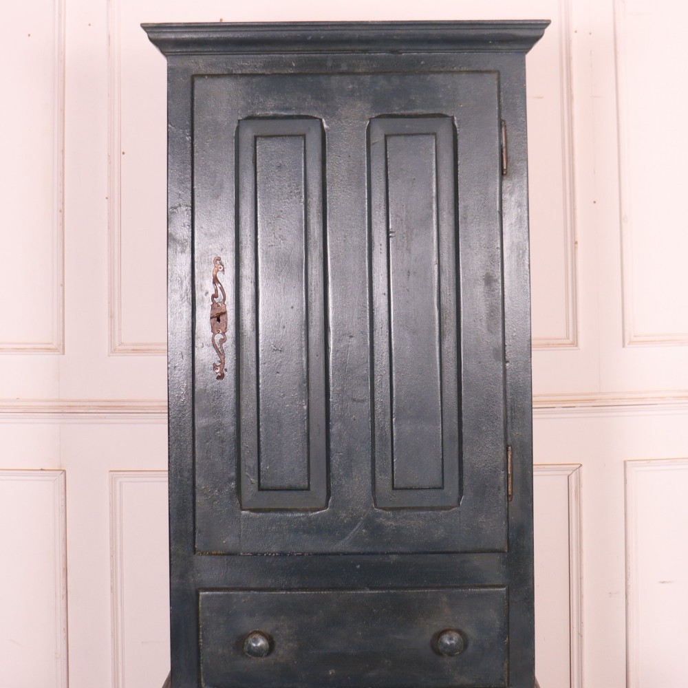 A tall, narrow antique French provincial food cupboard in a dark grey painted finish, featuring recessed upper panels, a central drawer, and a lower single-door cabinet. View II