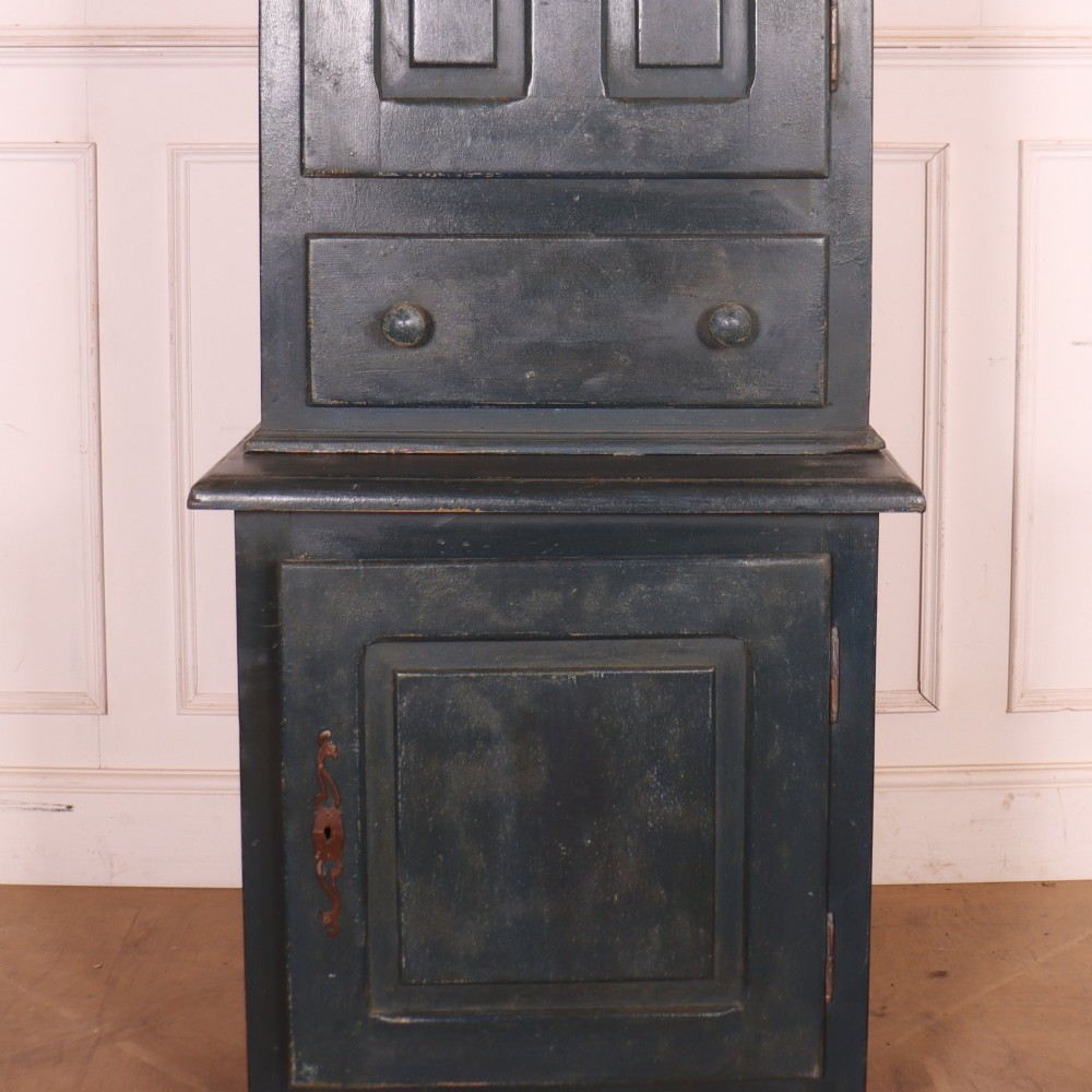 A tall, narrow antique French provincial food cupboard in a dark grey painted finish, featuring recessed upper panels, a central drawer, and a lower single-door cabinet. View III