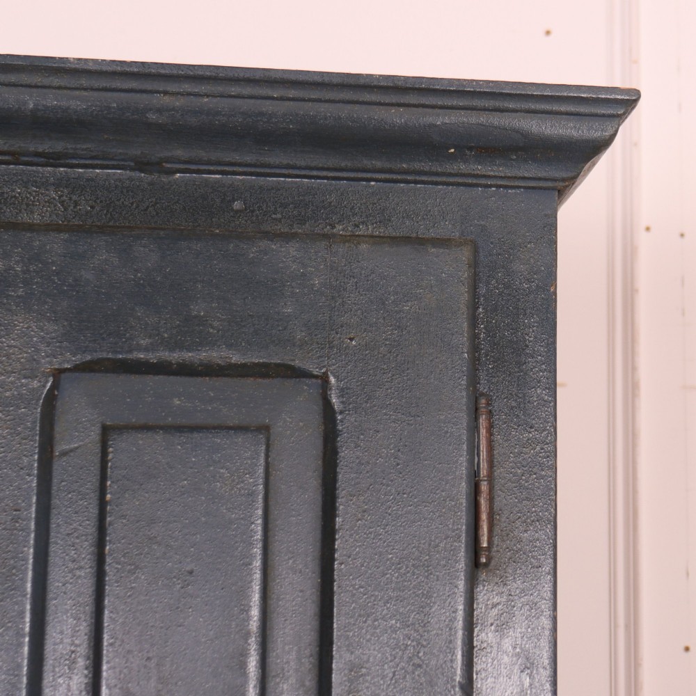 A tall, narrow antique French provincial food cupboard in a dark grey painted finish, featuring recessed upper panels, a central drawer, and a lower single-door cabinet. View VI