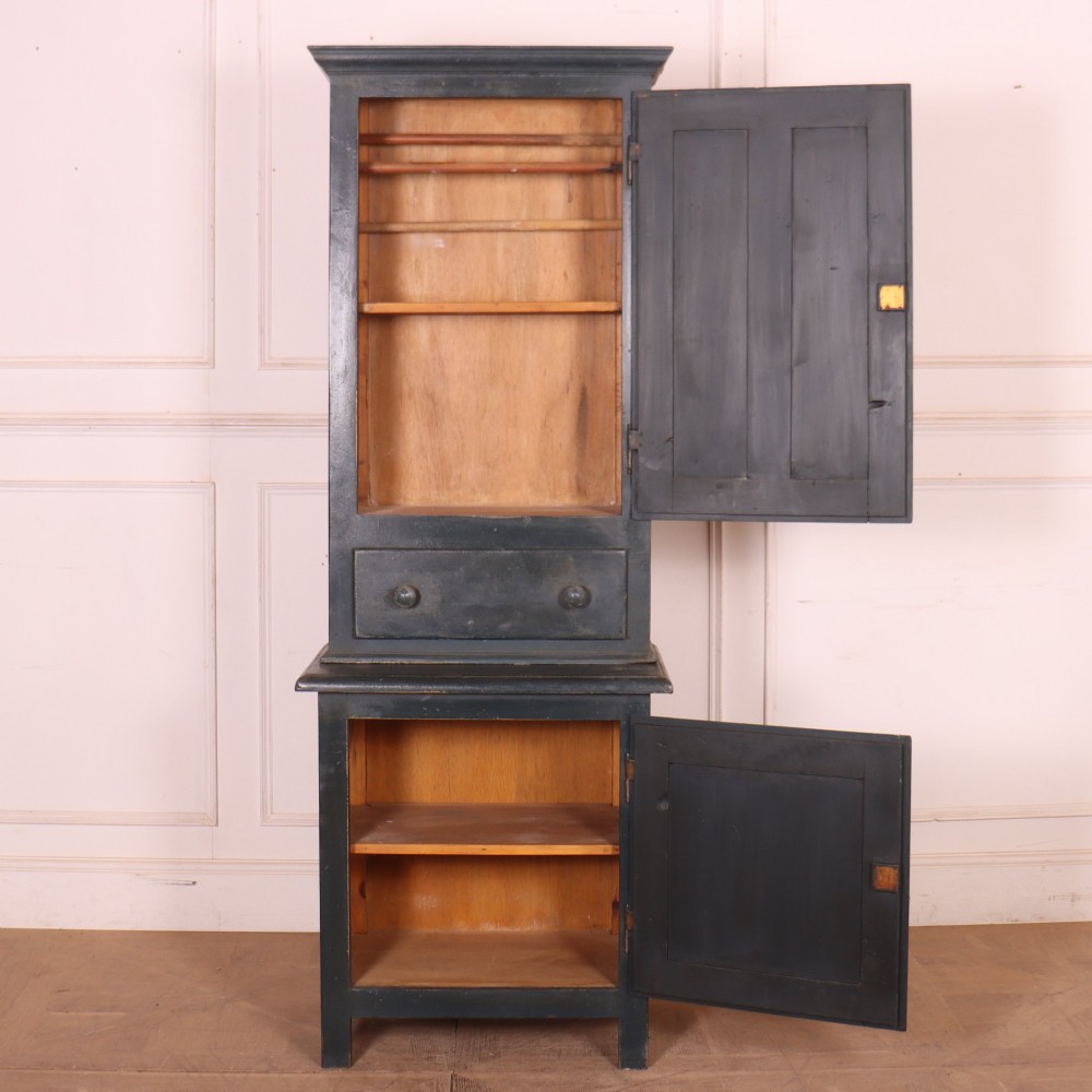 A tall, narrow antique French provincial food cupboard in a dark grey painted finish, featuring recessed upper panels, a central drawer, and a lower single-door cabinet. View VII