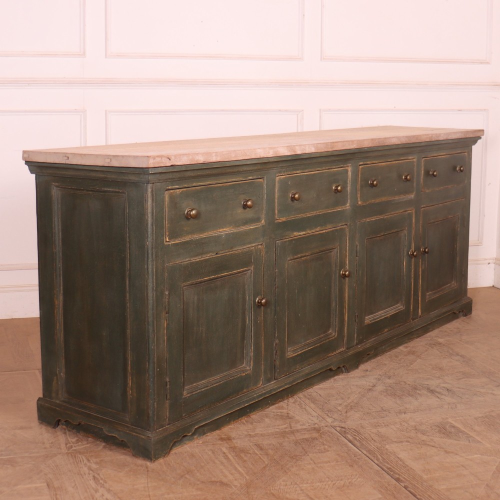 A long dark green painted wooden dresser base featuring four upper drawers over four panelled cupboard doors with a natural timber top. View II