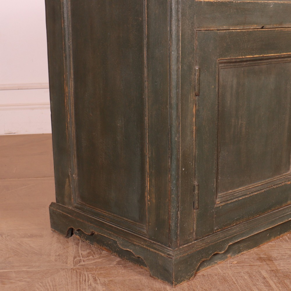 A long dark green painted wooden dresser base featuring four upper drawers over four panelled cupboard doors with a natural timber top. View XI