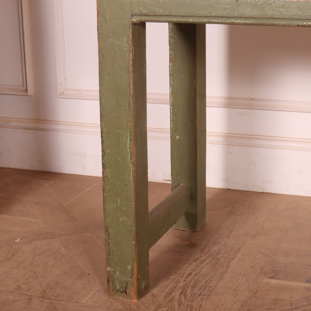 A long antique painted dresser base with four inline drawers, small brass knobs, a green frame, and a scrubbed wooden top. View III