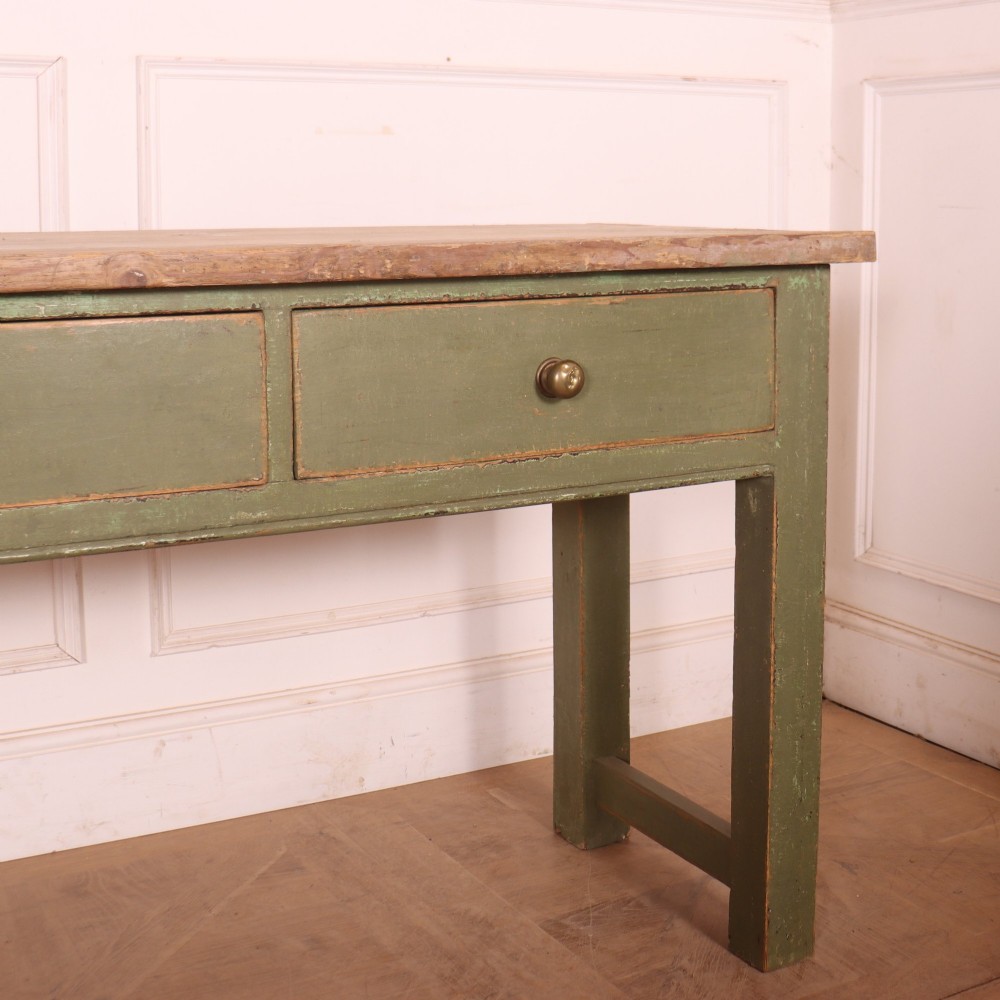 A long antique painted dresser base with four inline drawers, small brass knobs, a green frame, and a scrubbed wooden top. View IV