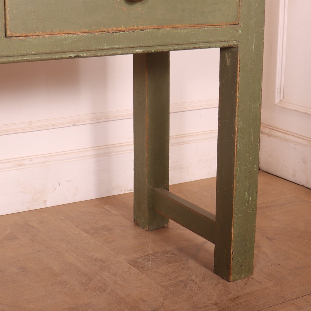 A long antique painted dresser base with four inline drawers, small brass knobs, a green frame, and a scrubbed wooden top. View V