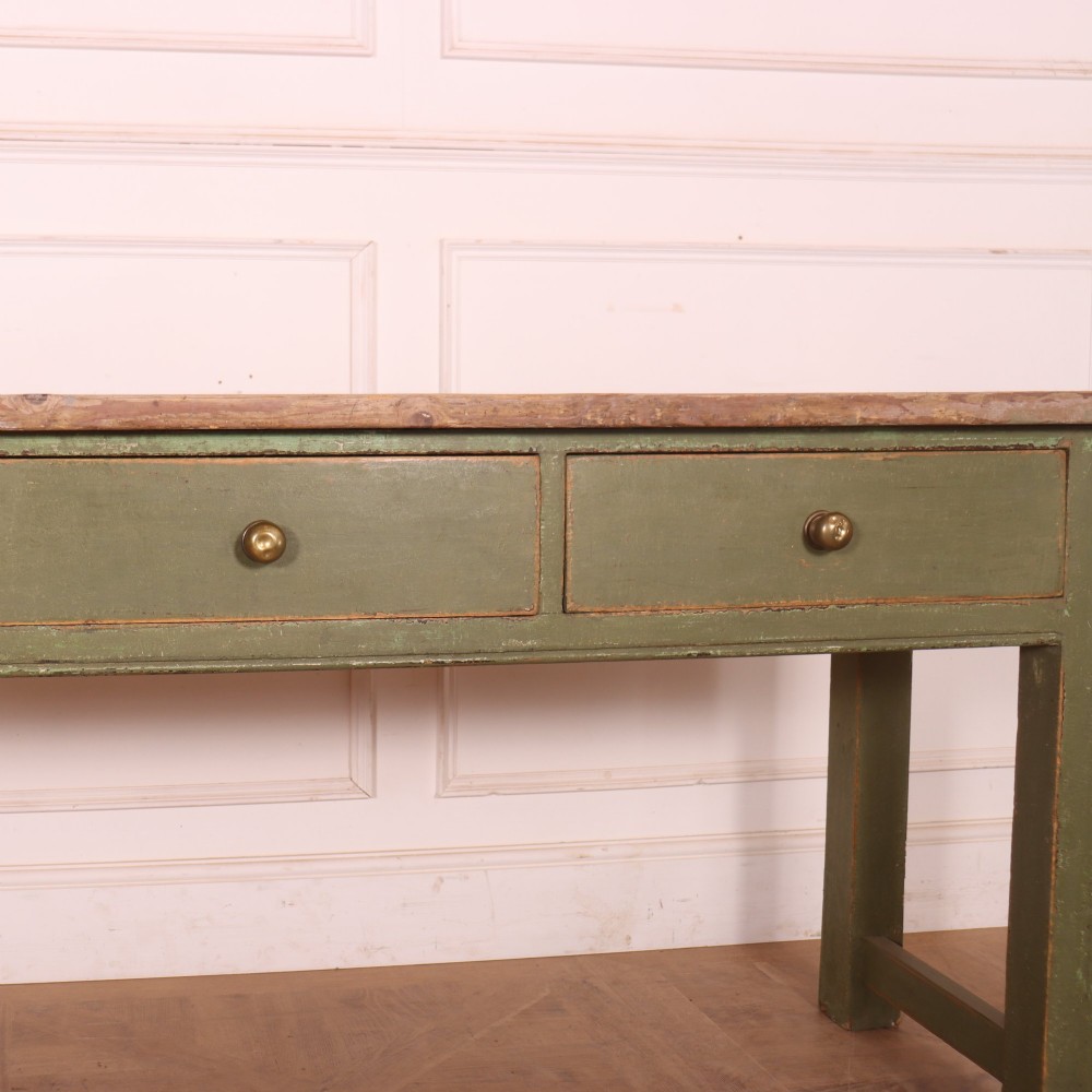 A long antique painted dresser base with four inline drawers, small brass knobs, a green frame, and a scrubbed wooden top. View VII