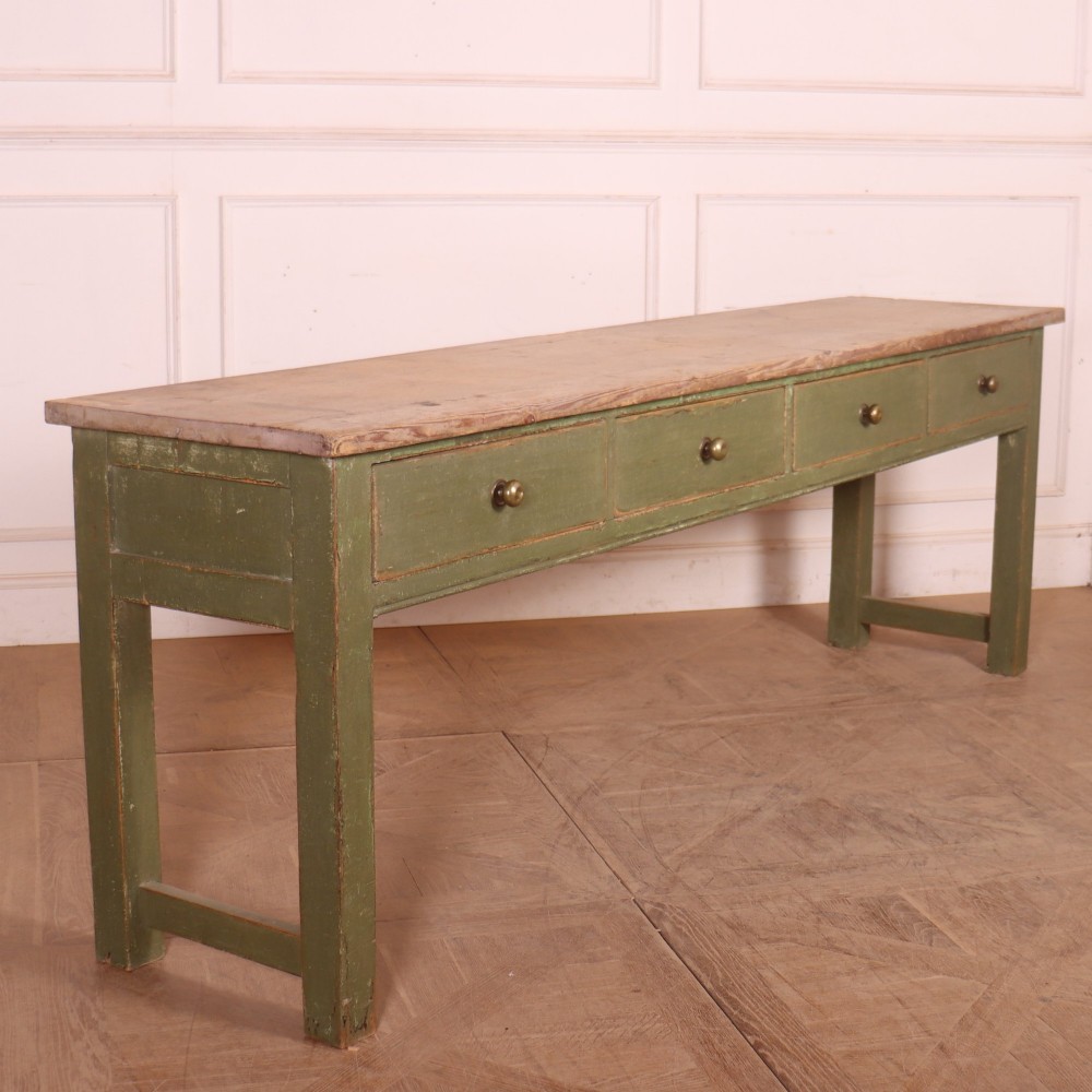 A long antique painted dresser base with four inline drawers, small brass knobs, a green frame, and a scrubbed wooden top. View VIII