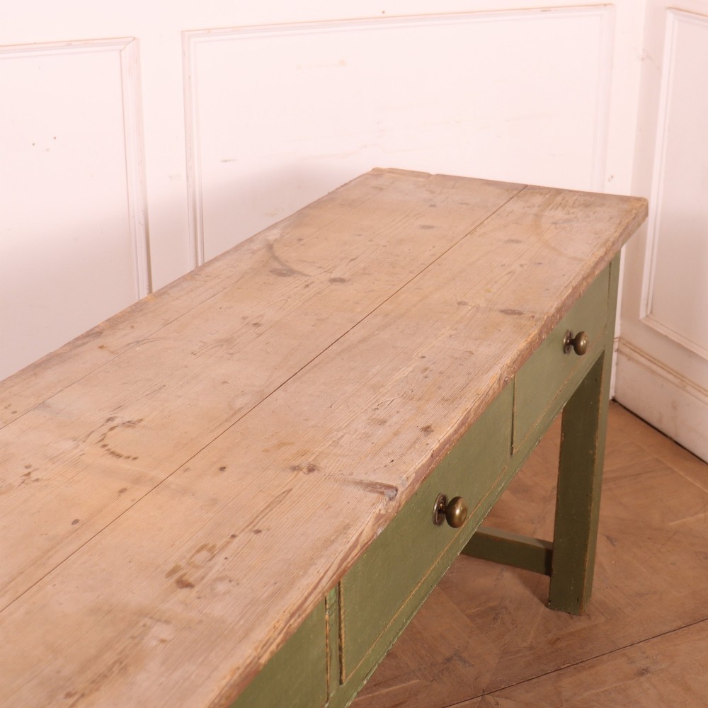 A long antique painted dresser base with four inline drawers, small brass knobs, a green frame, and a scrubbed wooden top. View X