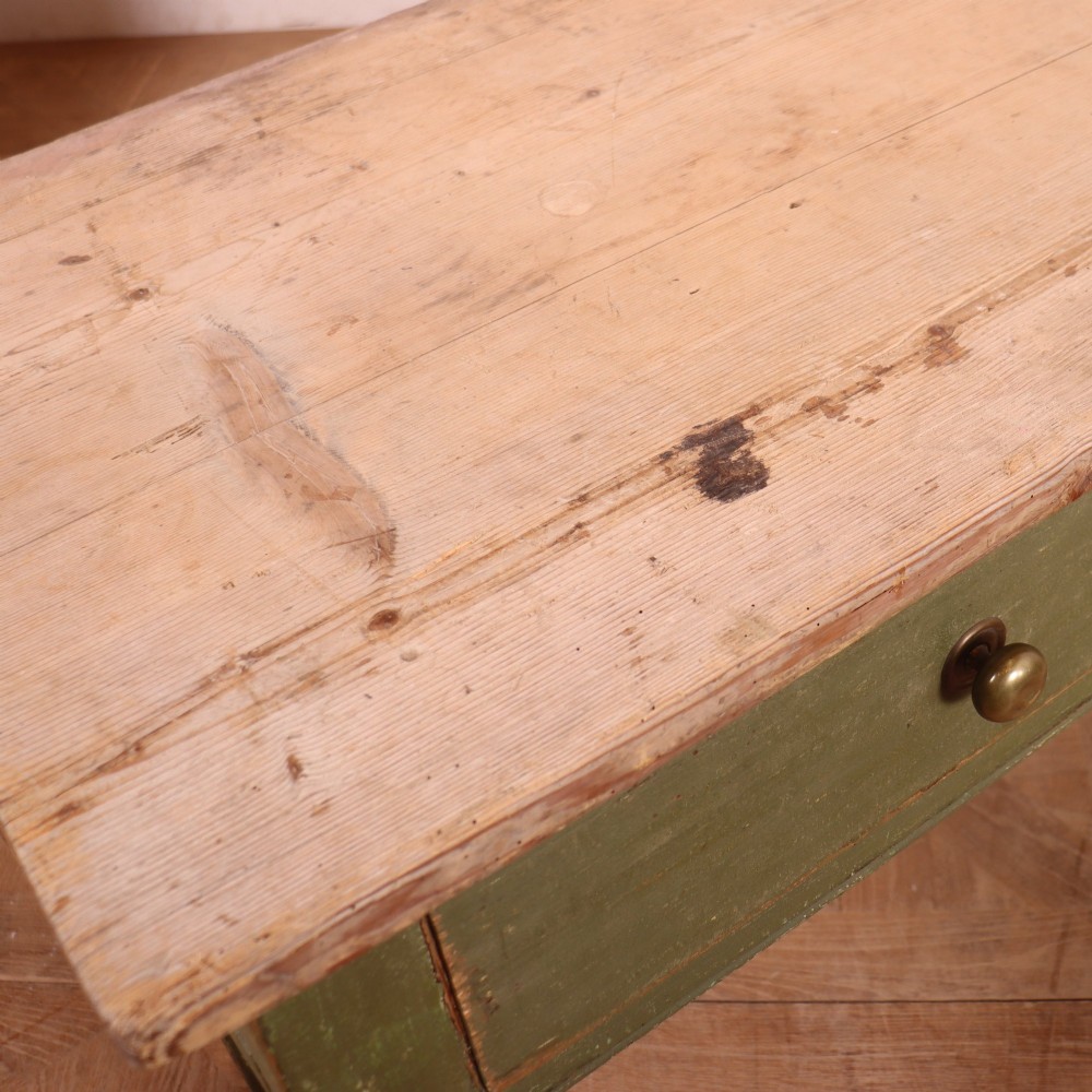 A long antique painted dresser base with four inline drawers, small brass knobs, a green frame, and a scrubbed wooden top. View XI