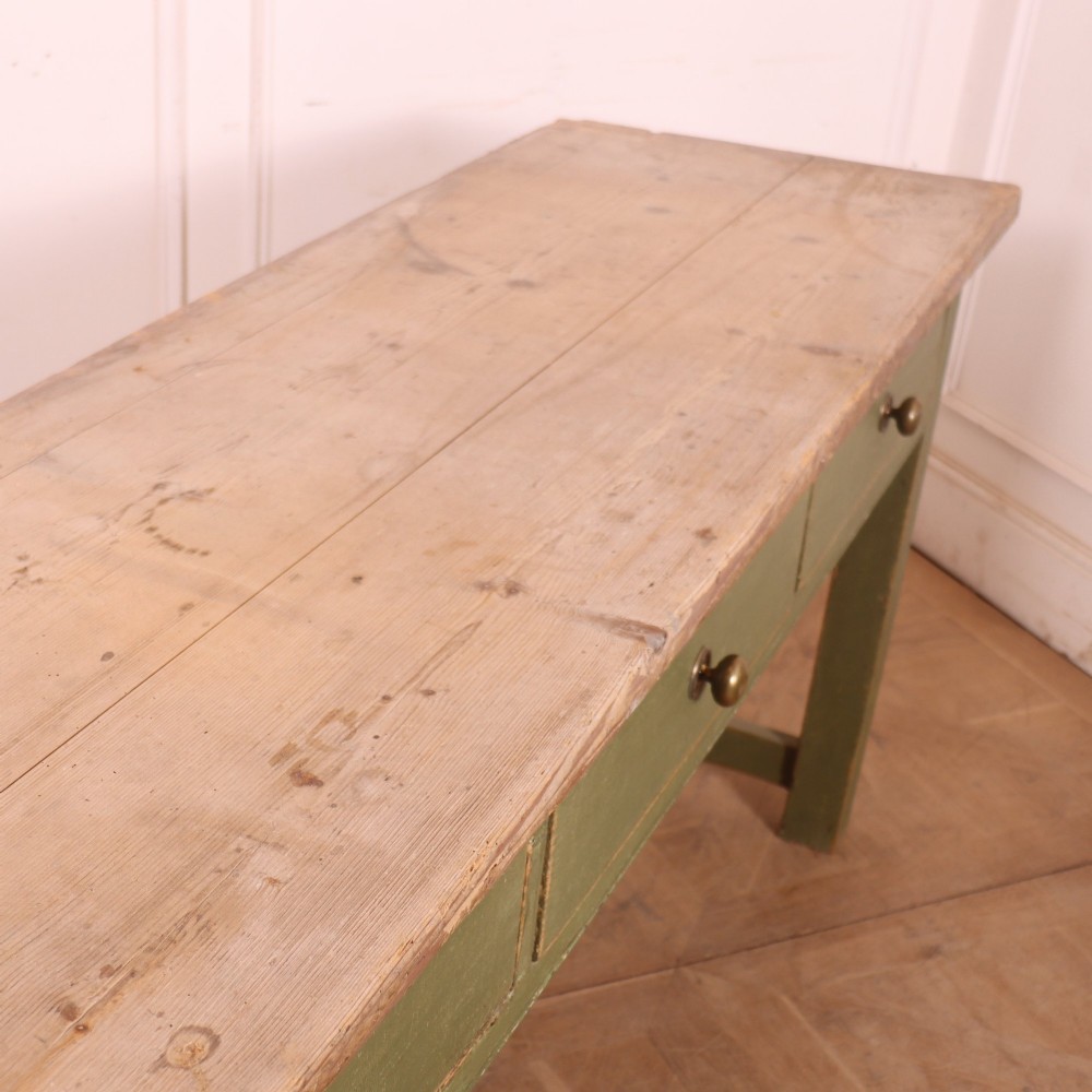 A long antique painted dresser base with four inline drawers, small brass knobs, a green frame, and a scrubbed wooden top. View XII