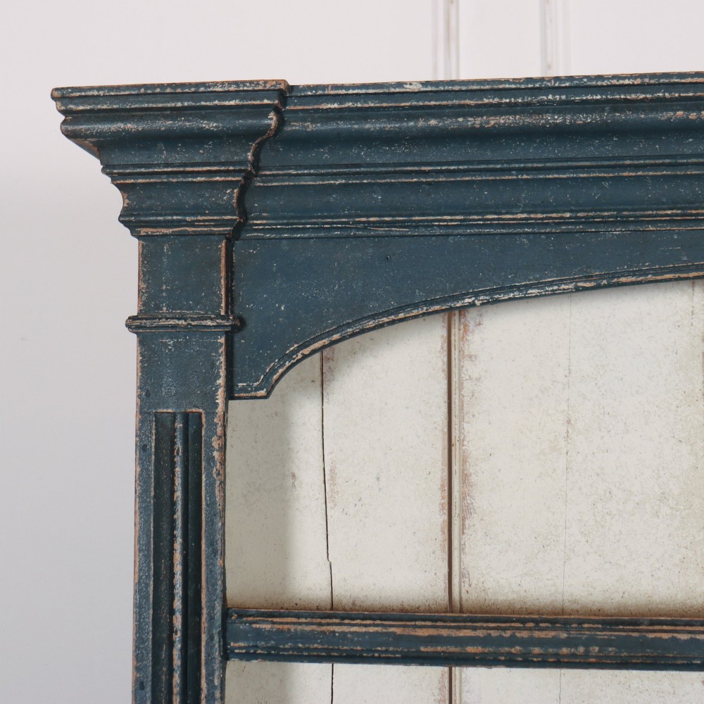 A large dark blue painted antique West Country dresser featuring an open plate rack with off-white backboards above three drawers and three panelled cupboard doors. View II