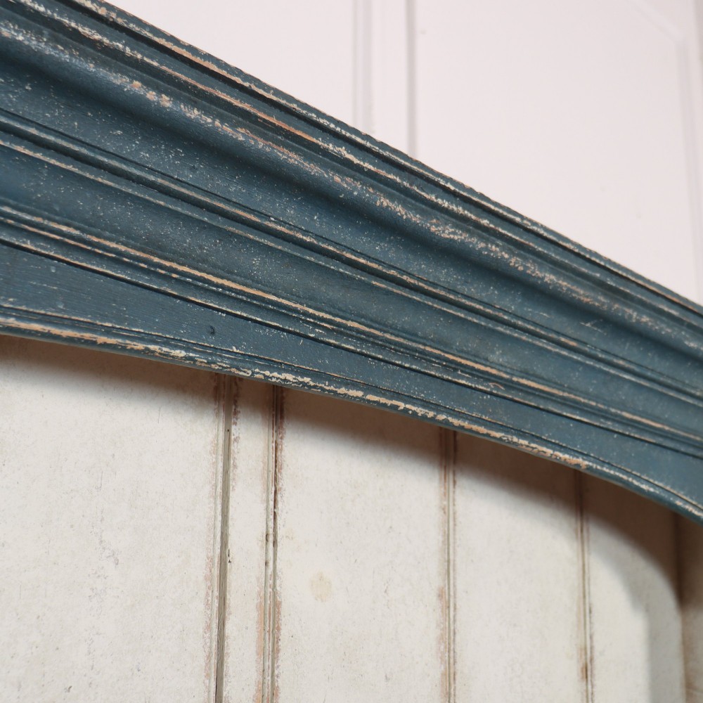 A large dark blue painted antique West Country dresser featuring an open plate rack with off-white backboards above three drawers and three panelled cupboard doors. View IV