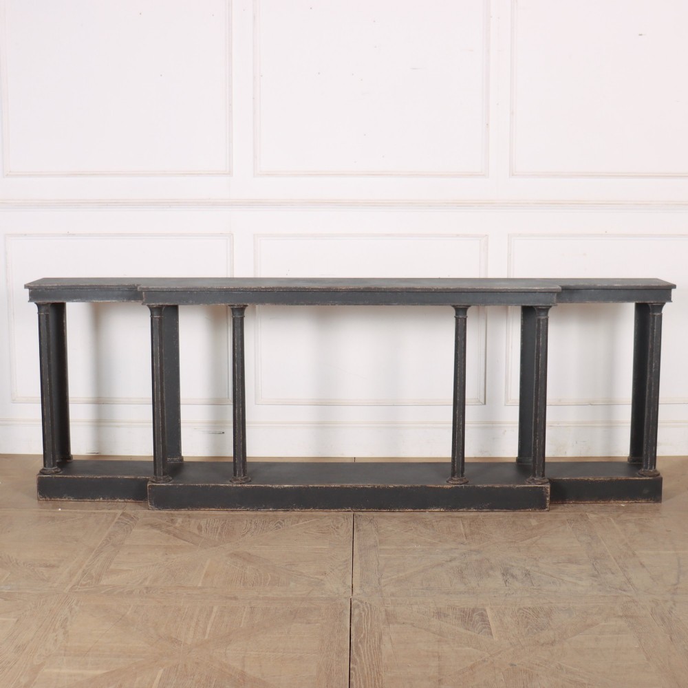 A long black painted beech console table featuring turned column legs and a solid plinth base. View II