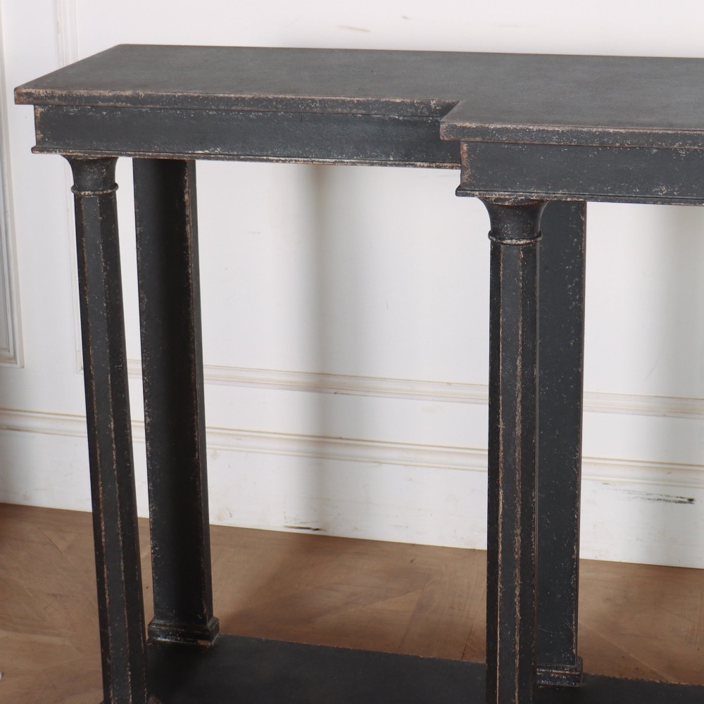 A long black painted beech console table featuring turned column legs and a solid plinth base. View III