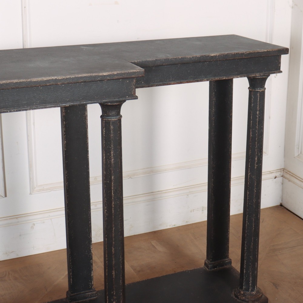 A long black painted beech console table featuring turned column legs and a solid plinth base. View V