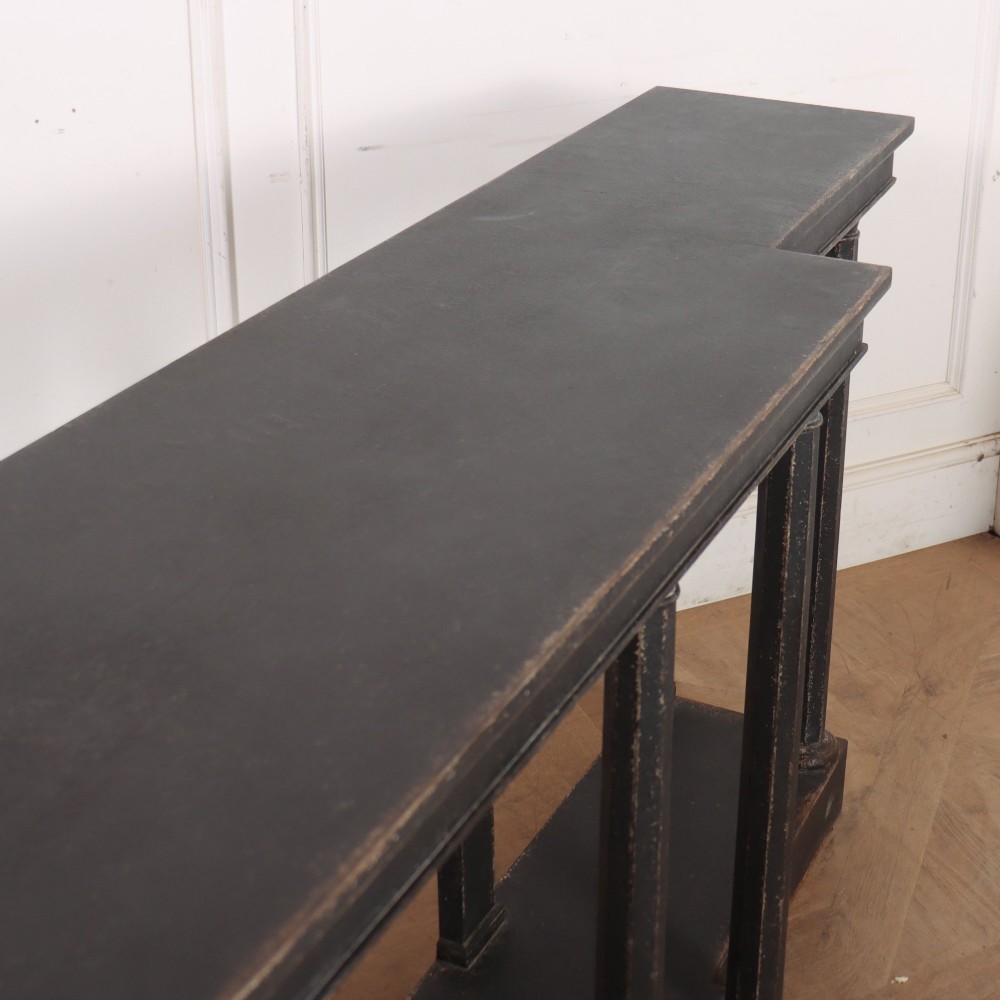 A long black painted beech console table featuring turned column legs and a solid plinth base. View X