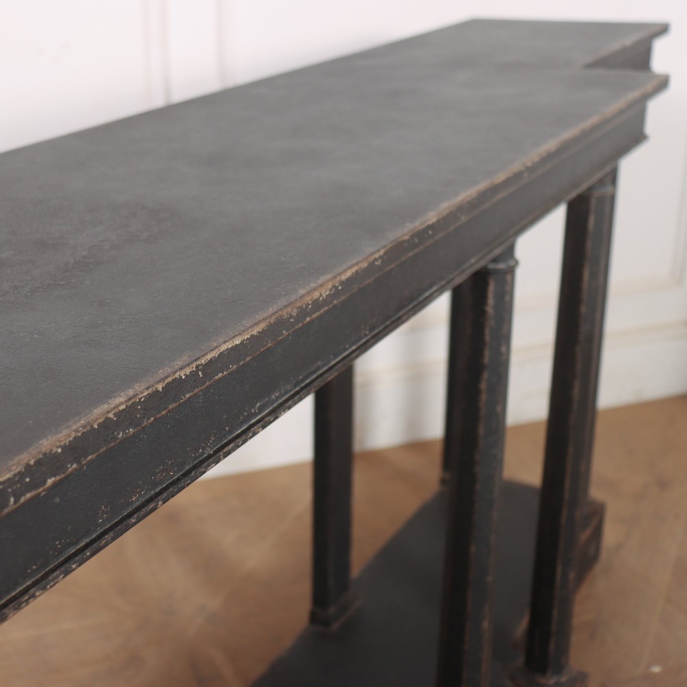 A long black painted beech console table featuring turned column legs and a solid plinth base. View XI