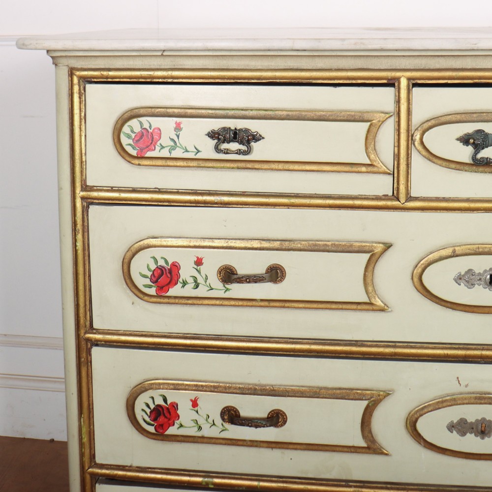 A 19th-century Spanish painted commode in cream featuring hand-painted red floral accents, gilded drawer mouldings, and brass handles. View II
