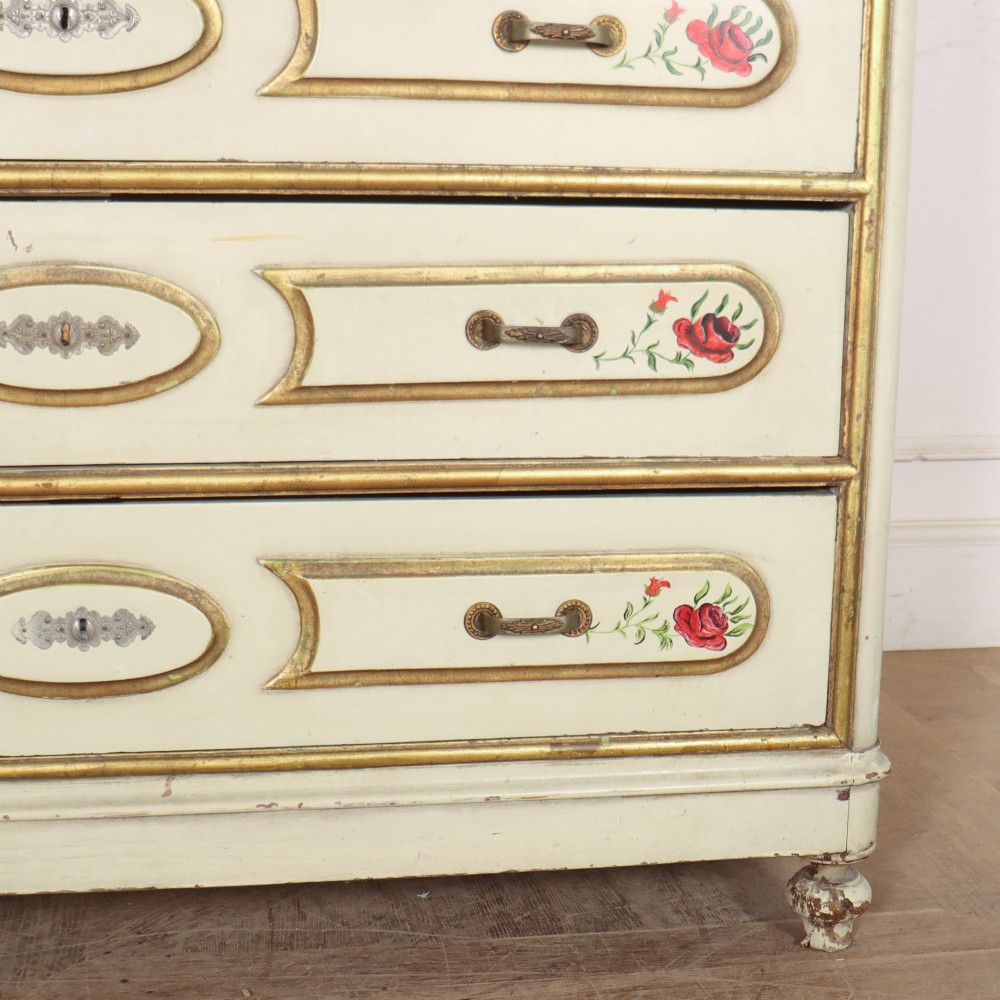 A 19th-century Spanish painted commode in cream featuring hand-painted red floral accents, gilded drawer mouldings, and brass handles. View IV
