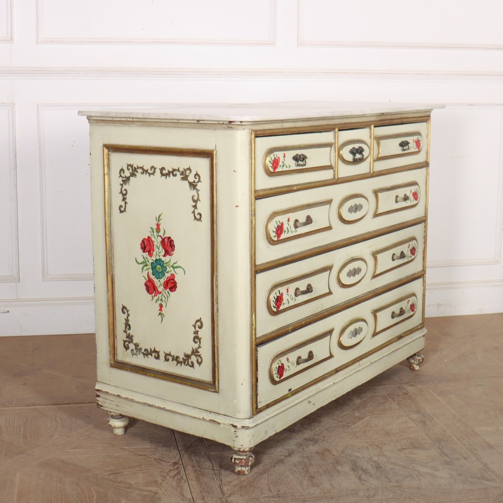 A 19th-century Spanish painted commode in cream featuring hand-painted red floral accents, gilded drawer mouldings, and brass handles. View VII