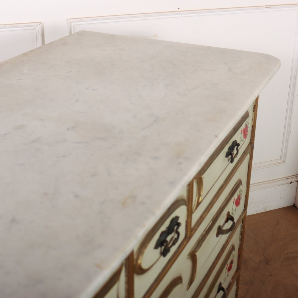 A 19th-century Spanish painted commode in cream featuring hand-painted red floral accents, gilded drawer mouldings, and brass handles. View IX