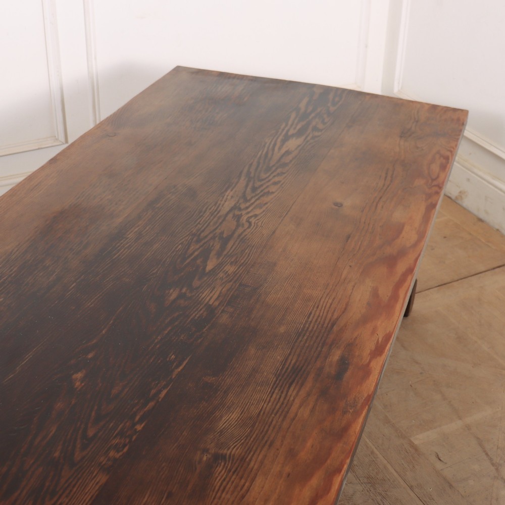 A long, dark oak low coffee table featuring hand-carved frieze panels and square legs joined by a low stretcher base. View VI