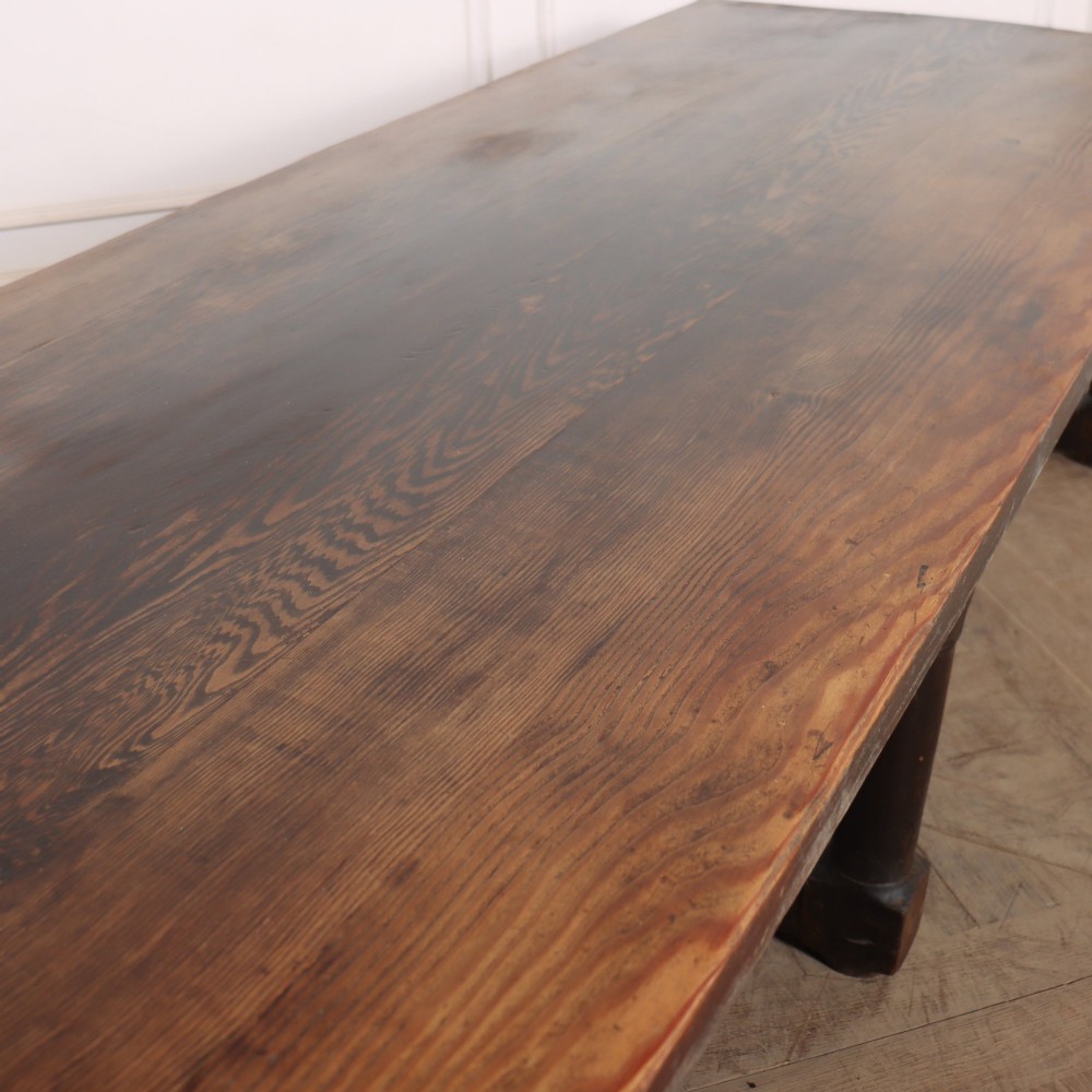 A long, dark oak low coffee table featuring hand-carved frieze panels and square legs joined by a low stretcher base. View VII