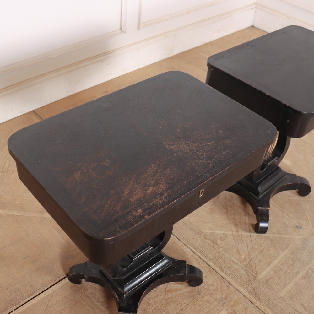 A pair of black ebonised side tables featuring single drawers with brass keyholes and lyre-shaped pedestal bases resting on scroll feet. View VI