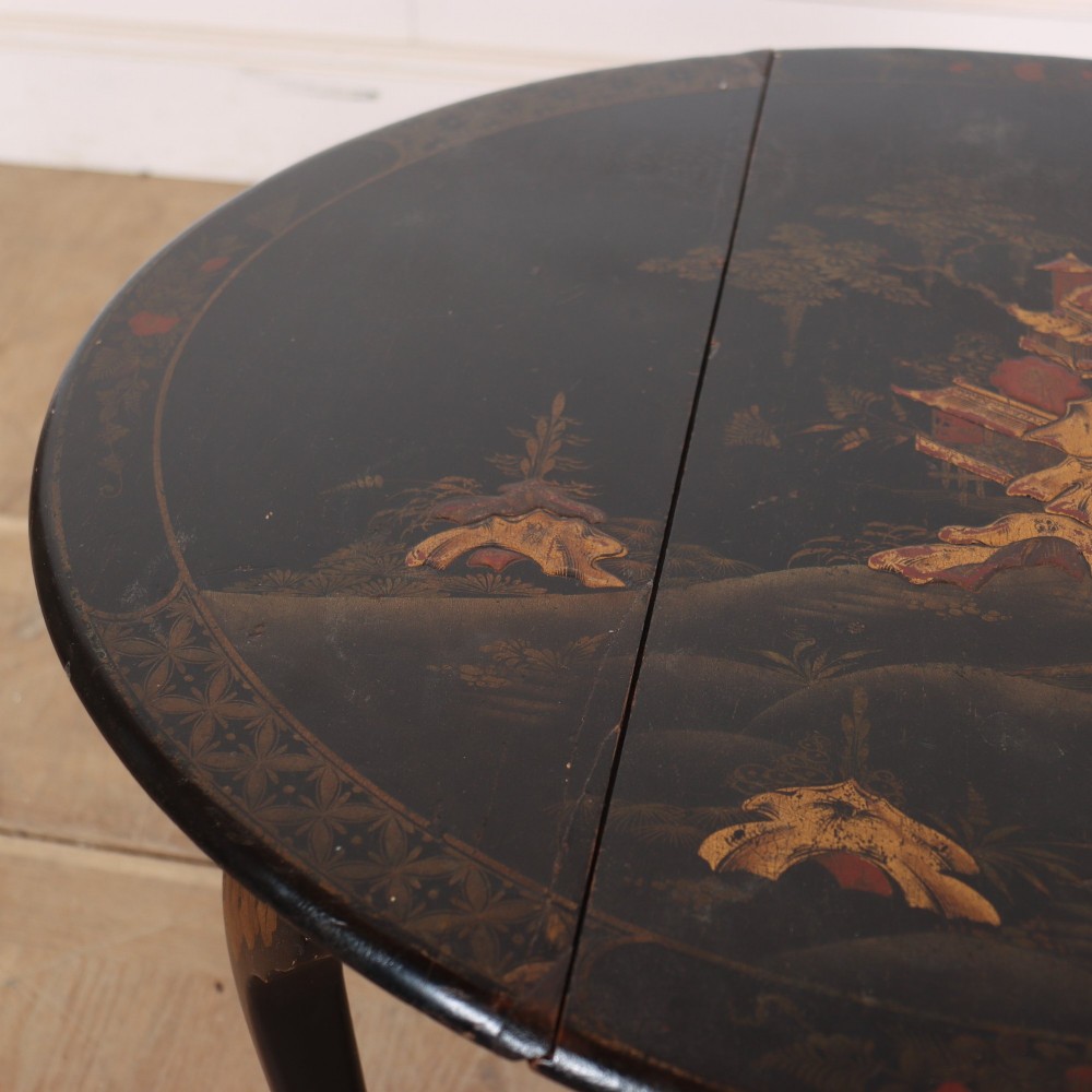 A small black lacquered drop-leaf side table featuring hand-painted gold Chinoiserie decoration and cabriole legs. View V