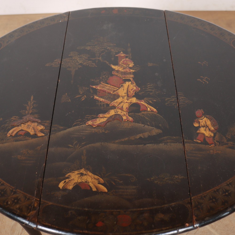 A small black lacquered drop-leaf side table featuring hand-painted gold Chinoiserie decoration and cabriole legs. View VI