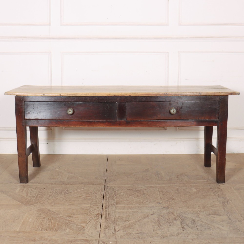 A long dark brown oak dresser base featuring two deep frieze drawers, circular metal knobs, and square legs joined by side stretchers.
