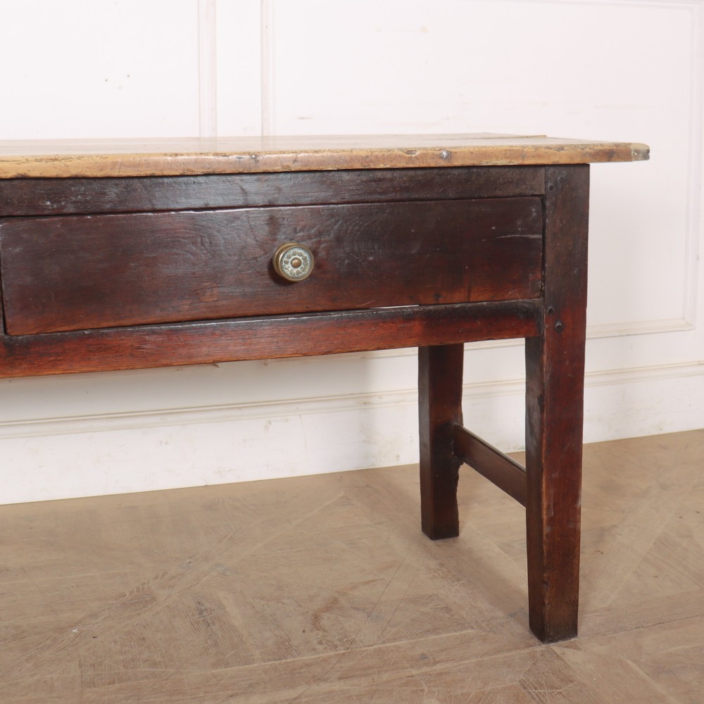 A long dark brown oak dresser base featuring two deep frieze drawers, circular metal knobs, and square legs joined by side stretchers. View IV