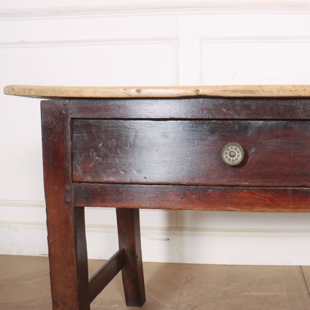 A long dark brown oak dresser base featuring two deep frieze drawers, circular metal knobs, and square legs joined by side stretchers. View VI