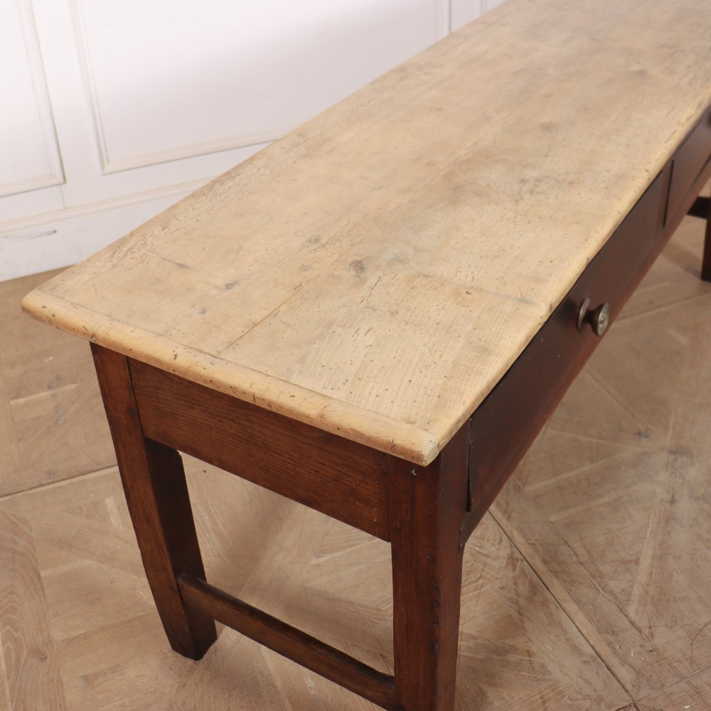 A long dark brown oak dresser base featuring two deep frieze drawers, circular metal knobs, and square legs joined by side stretchers. View VIII