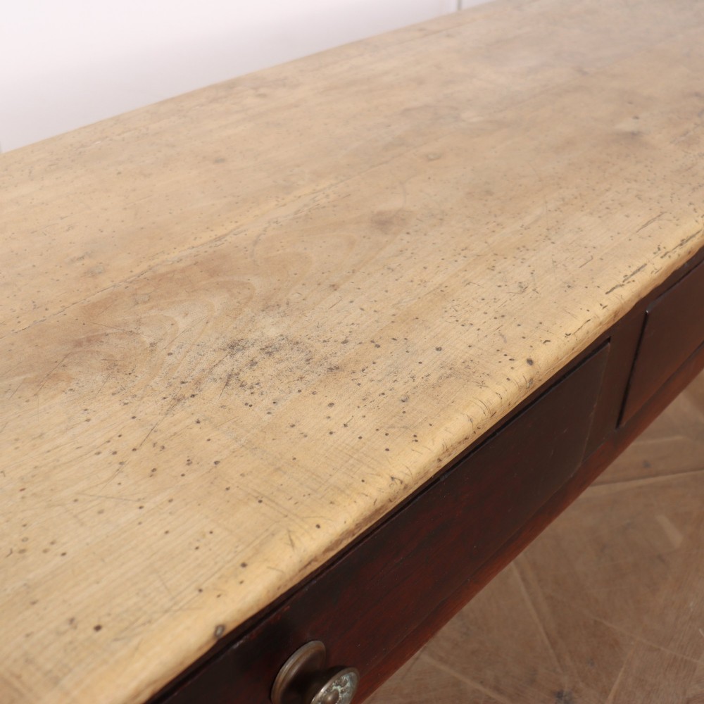 A long dark brown oak dresser base featuring two deep frieze drawers, circular metal knobs, and square legs joined by side stretchers. View X