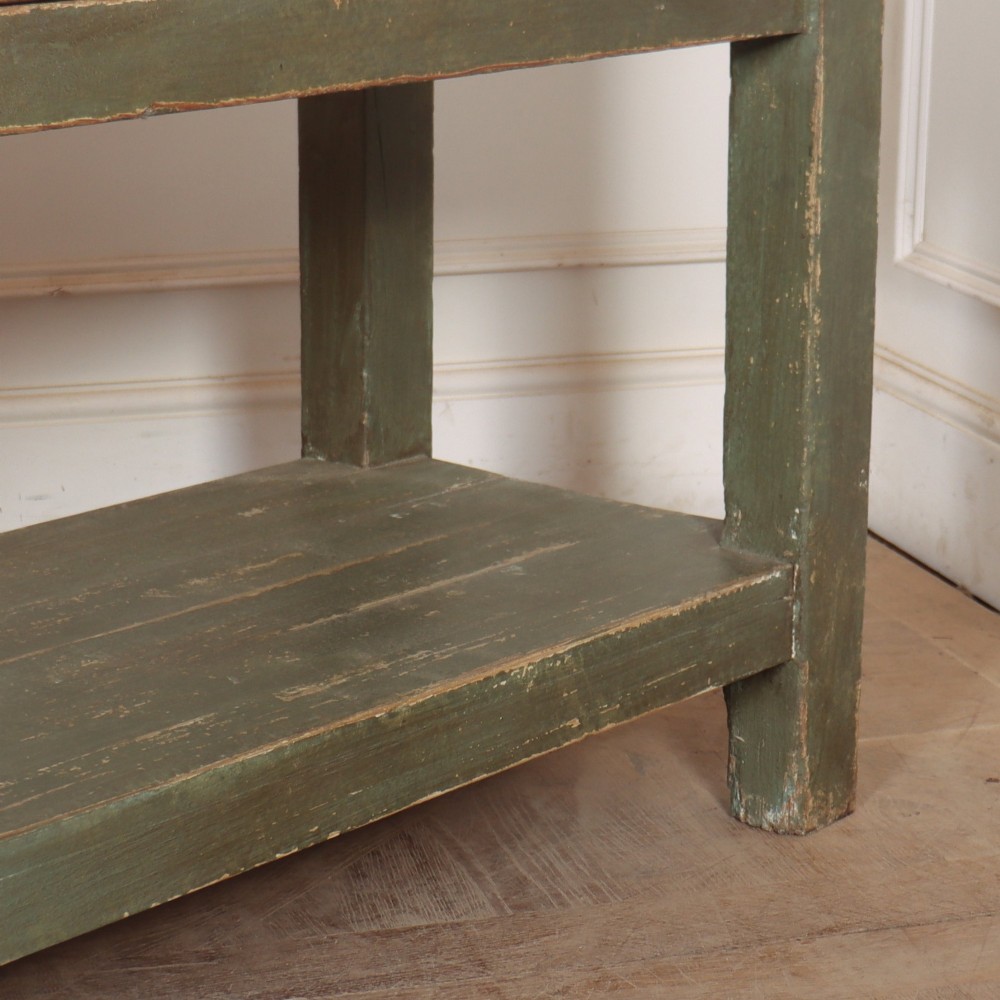 A long, green painted timber potboard serving table featuring two wide drawers with small round knobs and a continuous open shelf below. View VII