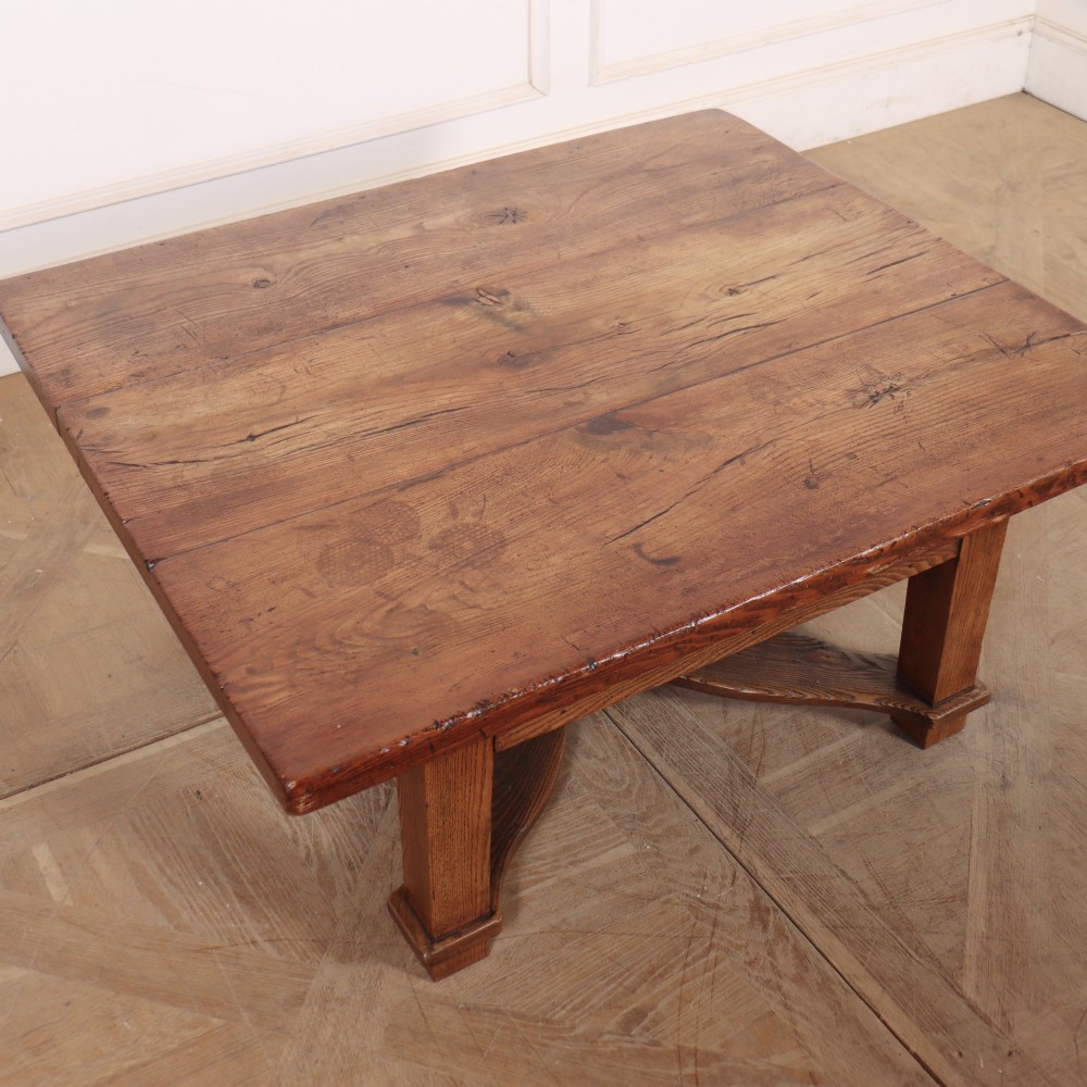 A square, low-profile coffee table crafted from solid brown elm featuring straight legs and an X-shaped cross-stretcher base. View III