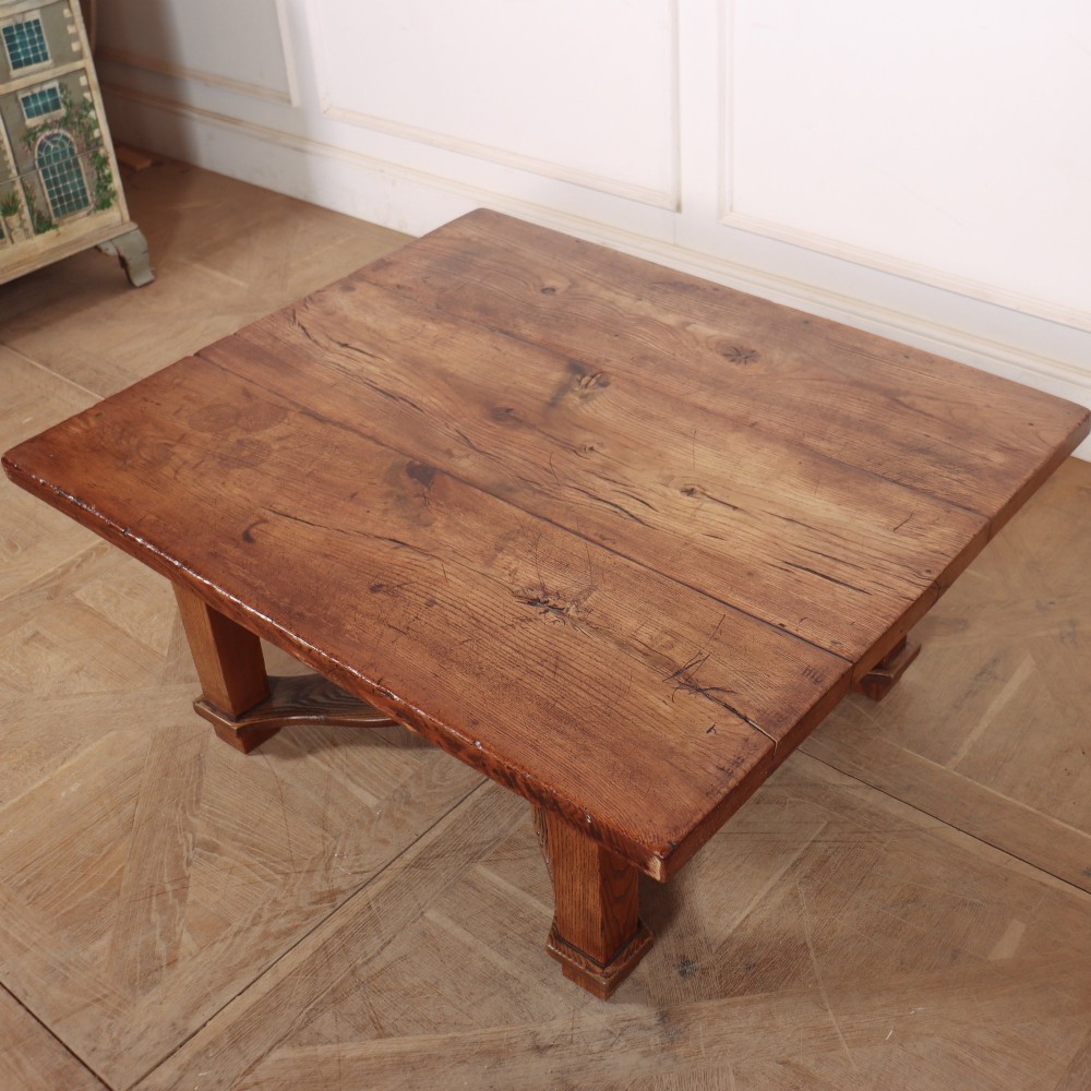 A square, low-profile coffee table crafted from solid brown elm featuring straight legs and an X-shaped cross-stretcher base. View V